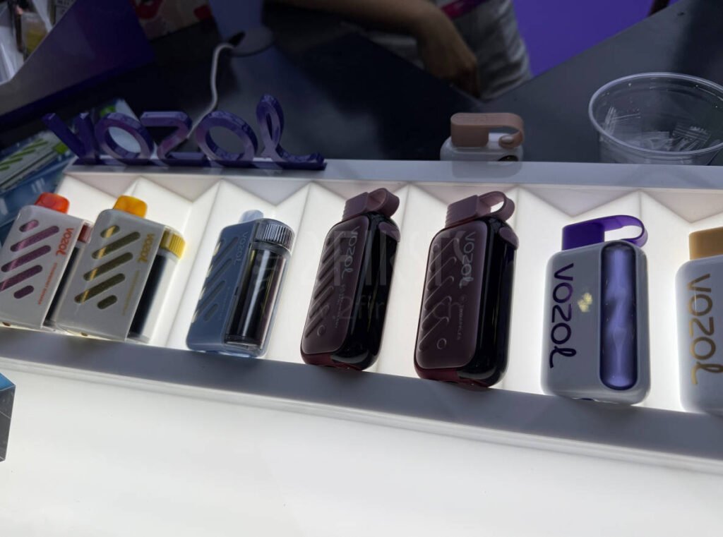 eight different flavors of the vozol 40000 vape displayed on a product stand
