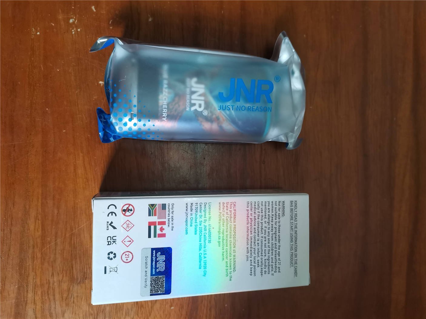 back of the jnr falcon x 18k packaging box placed next to the front of the product bag