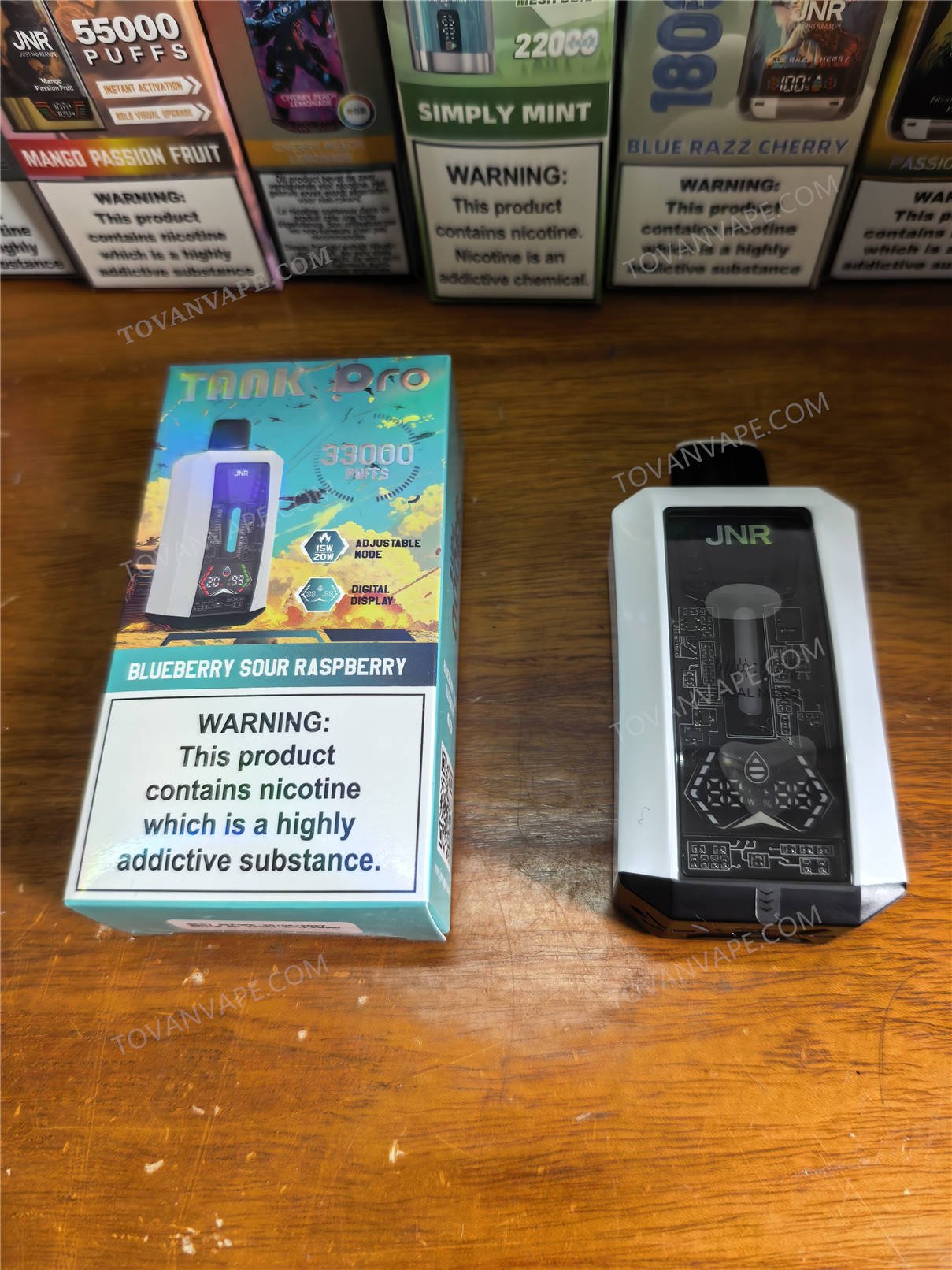 jnr tank pro 33000 in blueberry sour raspberry flavor shown from the front with its box