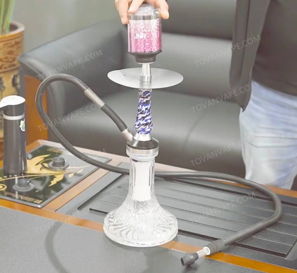 setting up the jnr mega shisha hookah 100k desktop vape station on a table